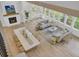 Spacious, light-filled living room featuring a fireplace, dining area, and a modern chandelier at 126 Sparrow Dr, Isle of Palms, SC 29451