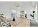 Bright living room with vaulted ceiling, hardwood floors, and large window at 126 Sparrow Dr, Isle of Palms, SC 29451