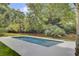 Modern pool with a geometric design, light-colored patio, and a lush lawn at 126 Sparrow Dr, Isle of Palms, SC 29451