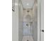 Luxurious shower with marble tile and gold shower fixtures at 126 Sparrow Dr, Isle of Palms, SC 29451