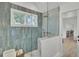 Bright blue tiled shower with glass door at 126 Sparrow Dr, Isle of Palms, SC 29451