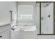 A soaking tub and glass shower are visible in this bright, modern bathroom at 1426 Tannery Row, Johns Island, SC 29455