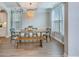 Inviting dining room features a modern chandelier, a large wood table, and windows at 1426 Tannery Row, Johns Island, SC 29455