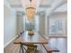 Spacious dining area with a rustic table, wood bench, modern light fixture and large windows with lots of natural light at 1426 Tannery Row, Johns Island, SC 29455