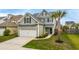 Beautiful two-story home with well-maintained lawn, attached garage, complemented by a mature palm tree at 1426 Tannery Row, Johns Island, SC 29455
