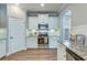 Stylish kitchen with stainless steel appliances, granite countertops, and modern white cabinets and a view to the side entrance at 1426 Tannery Row, Johns Island, SC 29455
