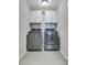 Modern laundry room with sleek washer and dryer, along with stylish upper cabinets at 1426 Tannery Row, Johns Island, SC 29455