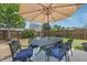 Outdoor patio features a dining table with umbrella, overlooking a fenced yard with established trees and landscaping at 1426 Tannery Row, Johns Island, SC 29455