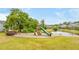 Community playground with a slide and swings sits beside a pond with a fountain and lush trees, with homes in the background at 1426 Tannery Row, Johns Island, SC 29455
