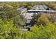 A high angle view shows the property surrounded by mature trees next to a neighborhood of mobile homes at 1456 Remount Rd, North Charleston, SC 29406