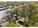 Aerial view of a charming home nestled among lush trees, with a detached garage or shed to the side of the property at 1456 Remount Rd, North Charleston, SC 29406