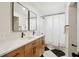 Modern bathroom with double vanity, white countertops, wood cabinets, and a shower with a white curtain at 1456 Remount Rd, North Charleston, SC 29406