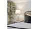 Bright bedroom featuring a side table with lamp and bamboo tree near the bed at 1456 Remount Rd, North Charleston, SC 29406