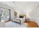 Cozy bedroom featuring a bed, side tables, and windows with natural light at 1456 Remount Rd, North Charleston, SC 29406