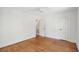 Bright, empty bedroom with hardwood floors, a ceiling fan, and a staircase entryway at 1456 Remount Rd, North Charleston, SC 29406