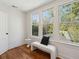 Bright bonus room with hardwood floors, large windows offering natural light, and a modern bench at 1456 Remount Rd, North Charleston, SC 29406
