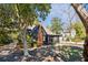 An exterior view shows a house with a chimney surrounded by shade trees at 1456 Remount Rd, North Charleston, SC 29406