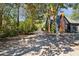 The exterior of the property shows a chimney and an adjacent driveway alongside mature trees at 1456 Remount Rd, North Charleston, SC 29406