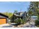 Charming home exterior with dark siding, fenced yard, and mature trees providing shade at 1456 Remount Rd, North Charleston, SC 29406