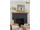 Modern black fireplace with mantle, adorned with decorative pieces and a framed artwork at 1456 Remount Rd, North Charleston, SC 29406