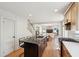 Open kitchen with a center island, stainless steel appliances, and hardwood floors in a bright space at 1456 Remount Rd, North Charleston, SC 29406
