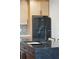 Granite-topped kitchen island with a sink, dark cabinetry, and stainless steel appliances in the background at 1456 Remount Rd, North Charleston, SC 29406