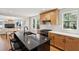 Modern kitchen with a granite island, light wood cabinets, and stainless steel appliances in an open layout at 1456 Remount Rd, North Charleston, SC 29406
