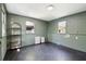 Spacious laundry room with dark tile floors, green concrete walls, two windows, and built in shelving at 1456 Remount Rd, North Charleston, SC 29406
