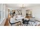 Bright living room featuring hardwood floors, a modern chandelier, and an open floor plan at 1456 Remount Rd, North Charleston, SC 29406
