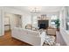 Bright living room featuring hardwood floors, a black fireplace, and a stylish sofa under a modern light fixture at 1456 Remount Rd, North Charleston, SC 29406