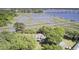 Breathtaking aerial perspective showcases a waterfront home nestled amongst lush, verdant foliage at 146 Rivers Edge Way, Wando, SC 29492