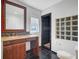 Bathroom with granite vanity, framed mirror, and dark tiled shower with decorative glass block window at 146 Rivers Edge Way, Wando, SC 29492