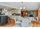 Open concept breakfast nook seamlessly connects to kitchen and living spaces with a fireplace at 146 Rivers Edge Way, Wando, SC 29492