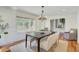 Bright dining room with hardwood floors, a modern chandelier, and a view of the outdoors at 146 Rivers Edge Way, Wando, SC 29492