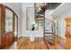 Bright foyer features beautiful wood floors and a spiral staircase at 146 Rivers Edge Way, Wando, SC 29492