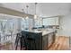 Gourmet kitchen with large island, barstool seating, mosaic tile backsplash, and view of the breakfast nook at 146 Rivers Edge Way, Wando, SC 29492