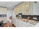 Kitchen features granite countertops, stainless steel sink, mosaic tile backsplash, and cabinets with glass doors at 146 Rivers Edge Way, Wando, SC 29492