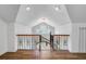 Landing area with hardwood floors, ornate black metal railing and an arched window at 146 Rivers Edge Way, Wando, SC 29492