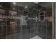 Shower featuring black tile, multiple shower heads, and built-in shelves for convenient storage at 146 Rivers Edge Way, Wando, SC 29492