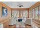 Bright sunroom features wood paneled walls and backyard views at 146 Rivers Edge Way, Wando, SC 29492