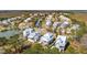 Stunning aerial view showcasing waterfront homes with beautiful landscaping and a tranquil neighborhood setting at 1604 Bernier Commons, Johns Island, SC 29455
