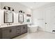 Modern bathroom has double vanity, standalone tub, and stylish fixtures for a spa-like experience at 1604 Bernier Commons, Johns Island, SC 29455