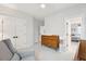Bright bedroom featuring a dresser, sitting chair, and doorway to another bedroom at 1604 Bernier Commons, Johns Island, SC 29455
