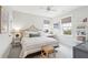 Bright bedroom with a decorative bed frame, a vanity, and two windows that let in plenty of light at 1604 Bernier Commons, Johns Island, SC 29455