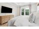 Bedroom with large TV features natural light and a cozy, relaxing ambiance at 1604 Bernier Commons, Johns Island, SC 29455