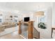 Spacious bonus room with hardwood stairs and railing that opens to a cozy seating area at 1604 Bernier Commons, Johns Island, SC 29455