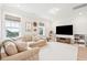 Open bonus room features a large sectional sofa, TV, and bright windows at 1604 Bernier Commons, Johns Island, SC 29455