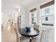 Bright dining area with modern windows and hardwood flooring connecting to the open-concept kitchen at 1604 Bernier Commons, Johns Island, SC 29455