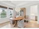 Bright dining area with modern lighting, natural wood table, and views of the outdoor scenery at 1604 Bernier Commons, Johns Island, SC 29455