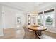 Dining area showcases a round wooden table, wicker chairs, and a modern chandelier at 1604 Bernier Commons, Johns Island, SC 29455